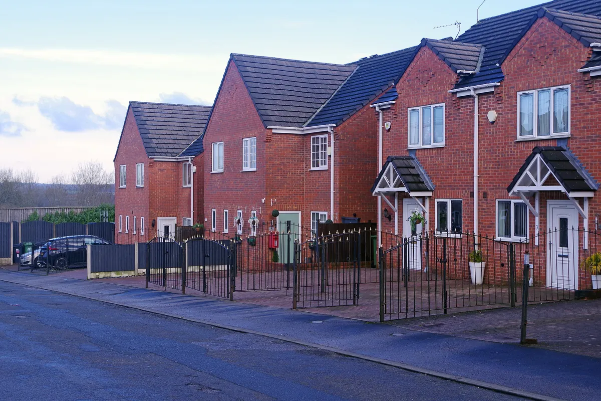 Newer red-brick semi-detached houses with railings and small front gardens on Priory Road in Alfreton