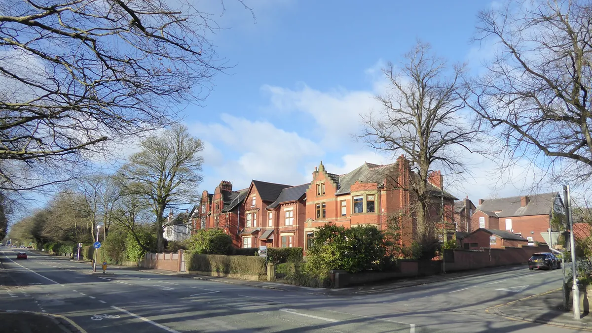 Red-brick Victorian villas behind hedges on Chorley New Road, Bolton