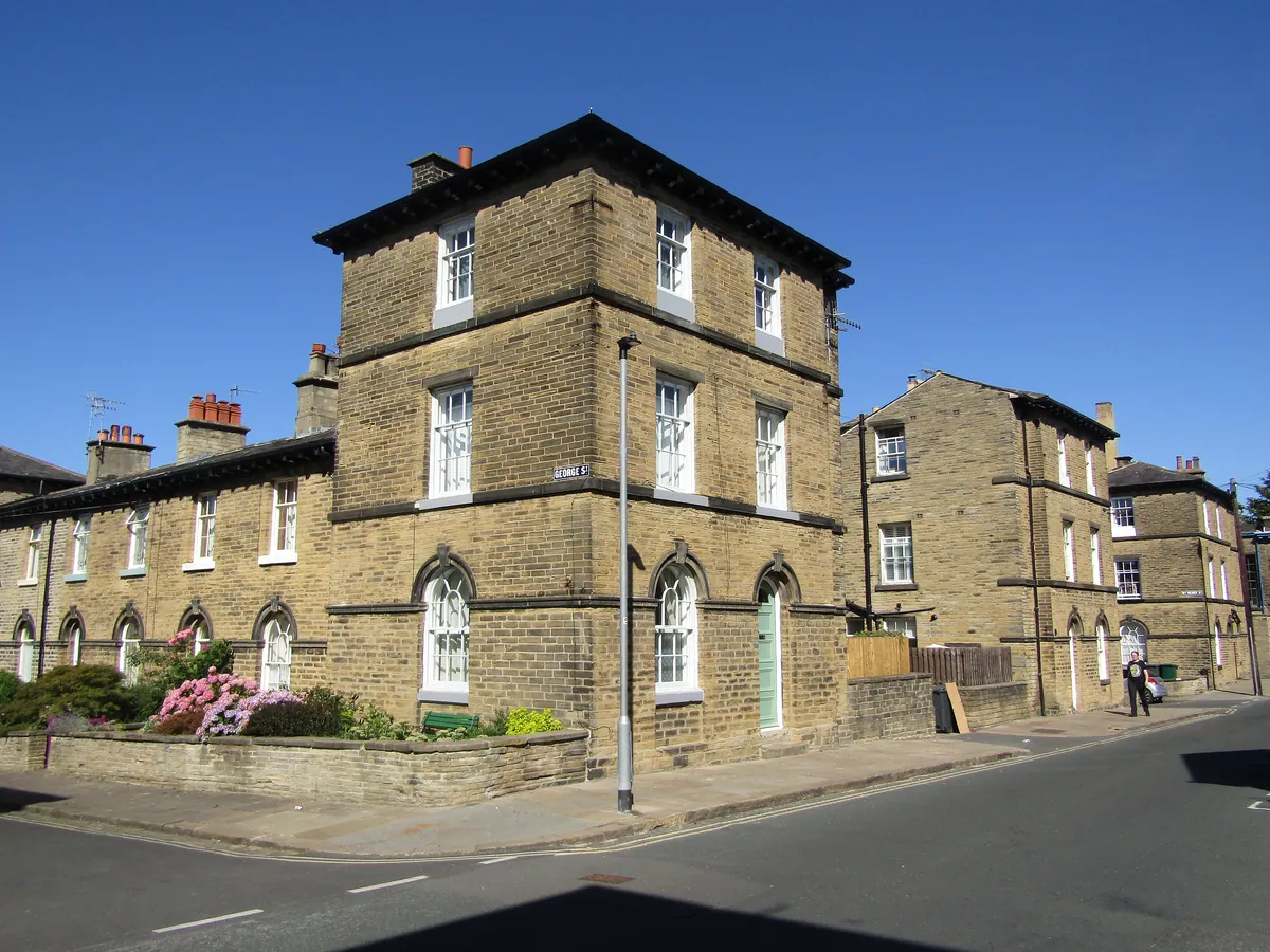 Stone terraced houses on the corner of Caroline Street in Saltaire