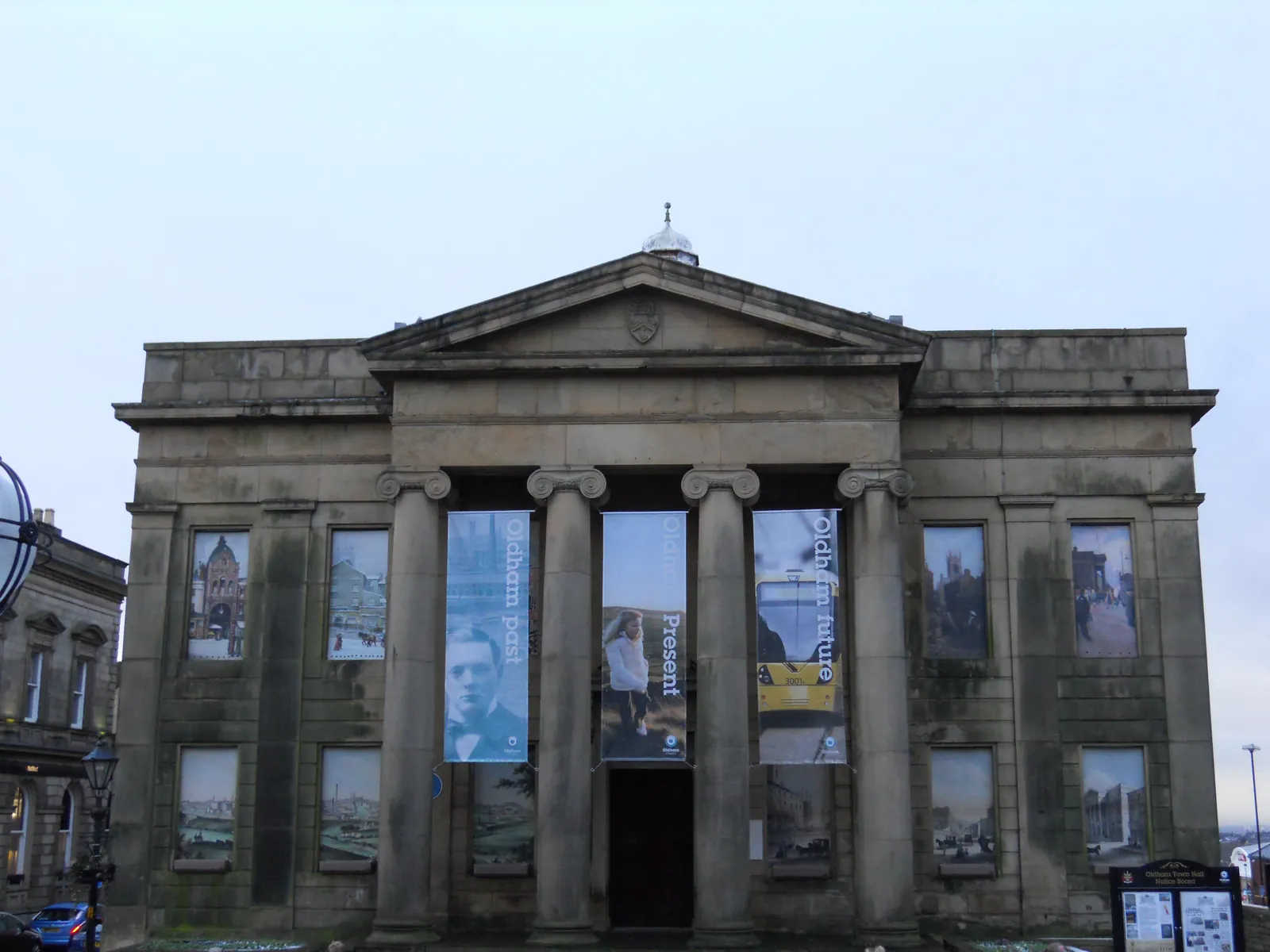 The columned stone front of Oldham's Old Town Hall under a pale sky