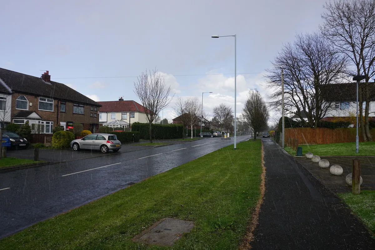 Semi-detached houses behind a wide grass verge on Etchells Road, Cheadle Hulme