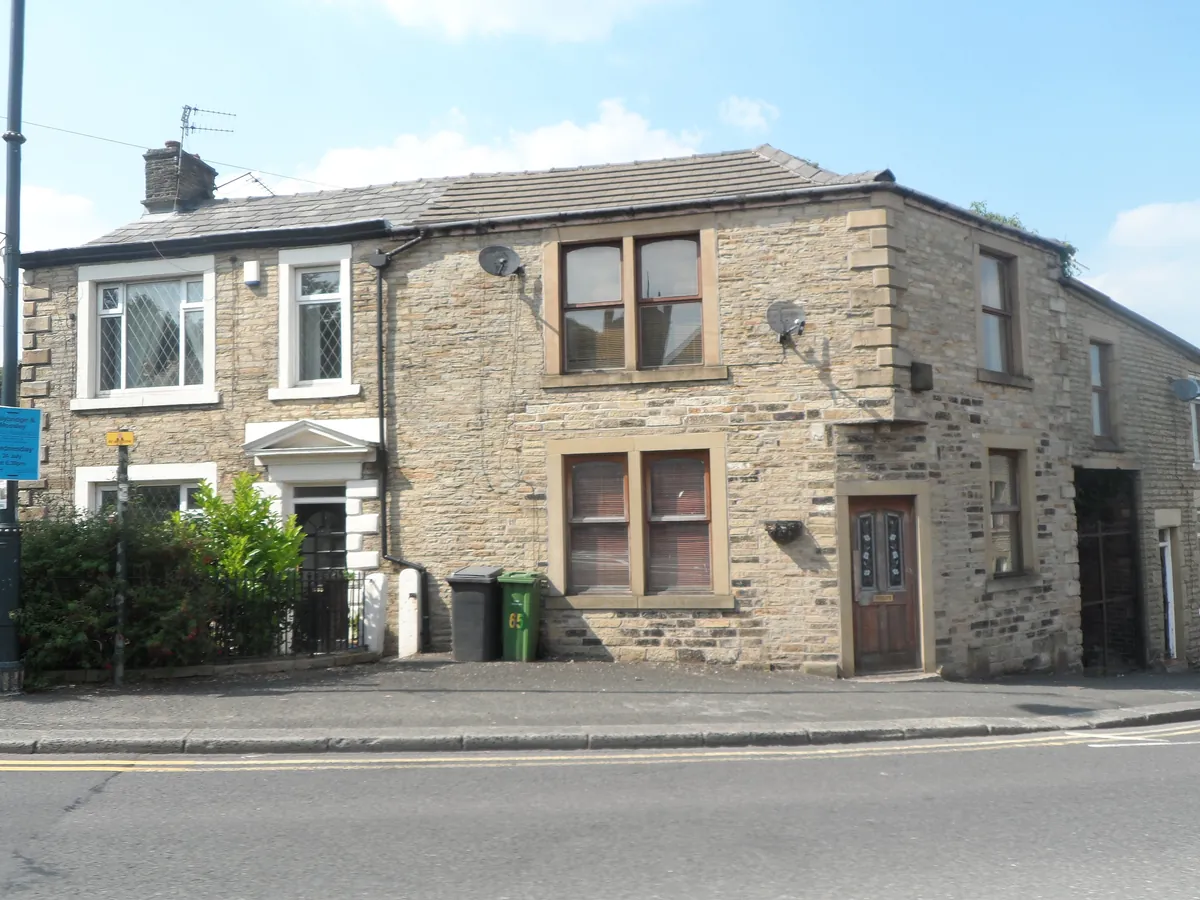 Stone-built houses on a street corner at Mossley Cross